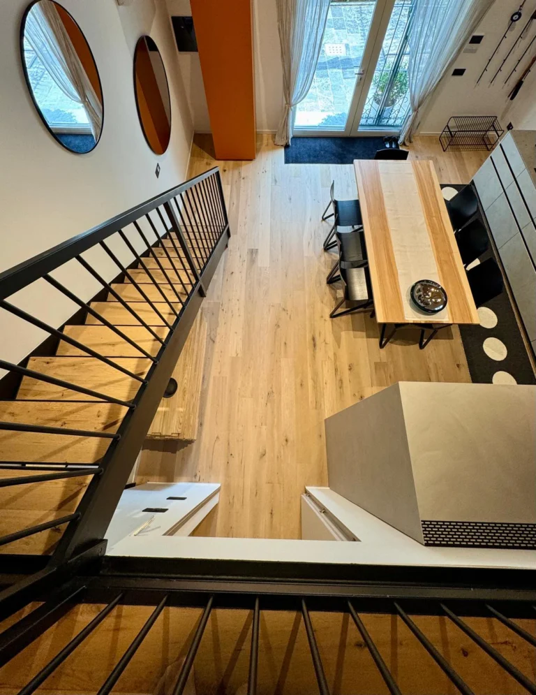 Seen from above, the connected levels reveal the apartment’s open layout and the daylight entering through the tall window